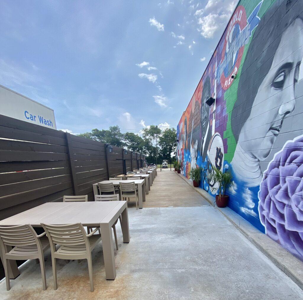 Mural in Madison, Alabama | The mural extends 22’ feet high by 80’ wide and encompasses the entire east-facing side of the restaurant. It features a slew of Alabama-connected individuals and symbols as well as people that have made an impact on Carlucci's personal journey.